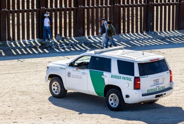 U.S. Border Patrol agents monitor groups of illegal immigrants who crossed into the United States in Jacumba, Calif., on Dec. 6, 2023. (John Fredricks/The Epoch Times)