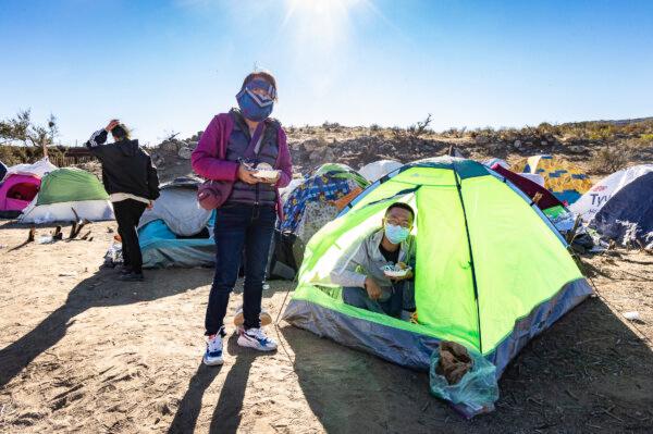 Chinese illegal immigrants settle at Willow Camp before being processed by Border Patrol agents in Jacumba, Calif., on Dec. 6, 2023. (John Fredricks/The Epoch Times)