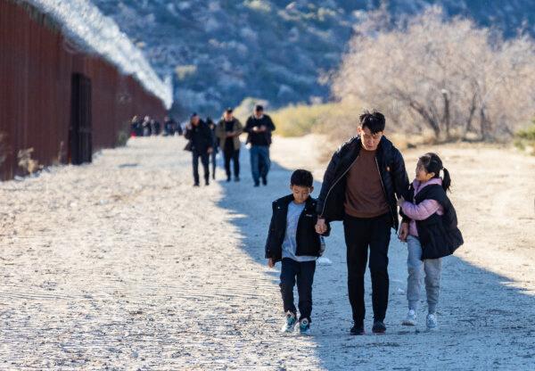 Chinese illegal immigrants walk together before being processed by Border Patrol agents in Jacumba, Calif., on Dec. 6, 2023. (John Fredricks/The Epoch Times)