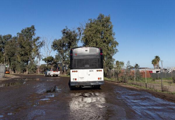 A bus driven by border patrol agents carrying illegal immigrants drives outside of San Diego, Calif., on Feb. 22, 2024. (John Fredricks/The Epoch Times)
