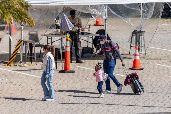 Illegal immigrants utilize shelter services provided by a nonprofit organization in San Diego on Feb. 22, 2024. (John Fredricks/The Epoch Times