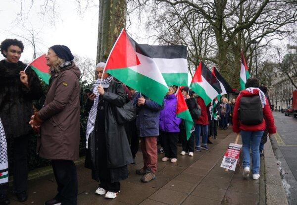People take part in a Palestine Solidarity Campaign rally outside the Houses of Parliament, London, as MPs debate calls for a ceasefire in Gaza on Feb. 21, 2024. (Lucy North/PA Wire)