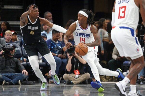 Los Angeles Clippers guard Terance Mann (14) drives to the basket as Memphis Grizzlies forward GG Jackson (45) defends during the first half in Memphis on Feb. 23, 2024. (Petre Thomas/USA TODAY Sports via Field Level Media)