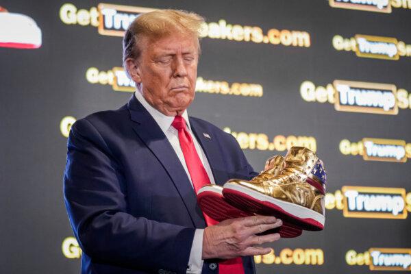 Former President Donald Trump holds a pair of gold Trump sneakers at SneakerCon in Philadelphia on Feb. 17, 2024. (Manuel Balce Ceneta/AP Photo)