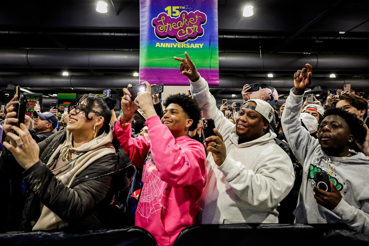 Attendees make videos and cheer as former President Donald Trump takes the stage to introduce a new line of signature shoes at SneakerCon in Philadelphia on Feb. 17, 2024. (Chip Somodevilla/Getty Images)