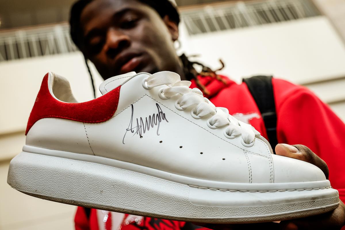 Omar Fofana of Reading, Pa., holds his sneaker that was autographed by former President Donald Trump at SneakerCon in Philadelphia on Feb. 17, 2024. (Chip Somodevilla/Getty Images)