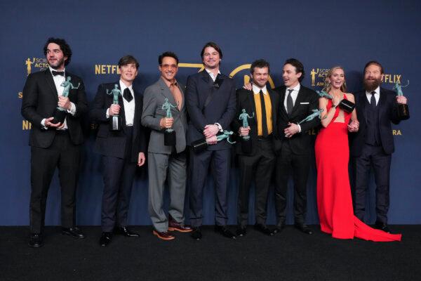 Benny Safdie, from left, Cillian Murphy, Robert Downey Jr., Josh Hartnett, Alden Ehrenreich, Casey Affleck, Emily Blunt, and Kenneth Branagh, winners of the award for the award for outstanding performance by a cast in a motion picture for "Oppenheimer," pose in the press room during the 30th annual Screen Actors Guild Awards at the Shrine Auditorium in Los Angeles on Feb. 24, 2024. (Chris Pizzello/AP Photo)