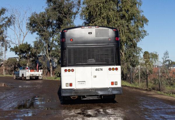 An illegal immigrant bus driven by border patrol agents drives outside of San Diego on Feb. 22, 2024. (John Fredricks/The Epoch Times)