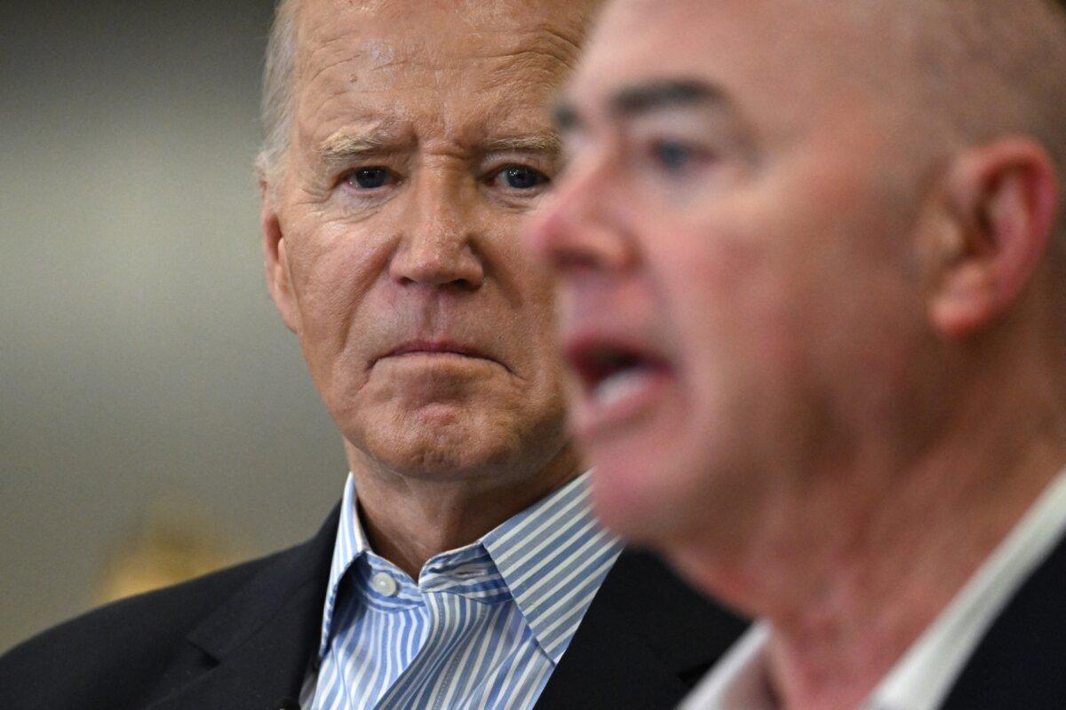 President Joe Biden (L) listens as Homeland Security Secretary Alejandro Mayorkas speaks at the Brownsville Station during a visit to the U.S.–Mexico border in Brownsville, Texas, on Feb. 29, 2024. (Jim Watson/AFP via Getty Images)