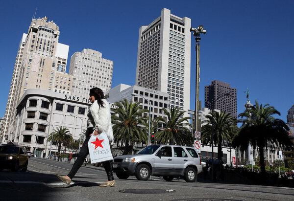 A pedestrian carries a shopping bag from Macy's as she walks through Union Square in San Francisco on Feb. 22, 2011. (Justin Sullivan/Getty Images)