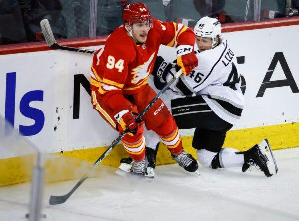 Los Angeles Kings forward Blake Lizotte (46) is checked by Calgary Flames defenseman Brayden Pachal (94) during the second period of an NHL hockey game in Calgary, Alberta, on Feb. 27, 2024. (Jeff McIntosh/The Canadian Press via AP)