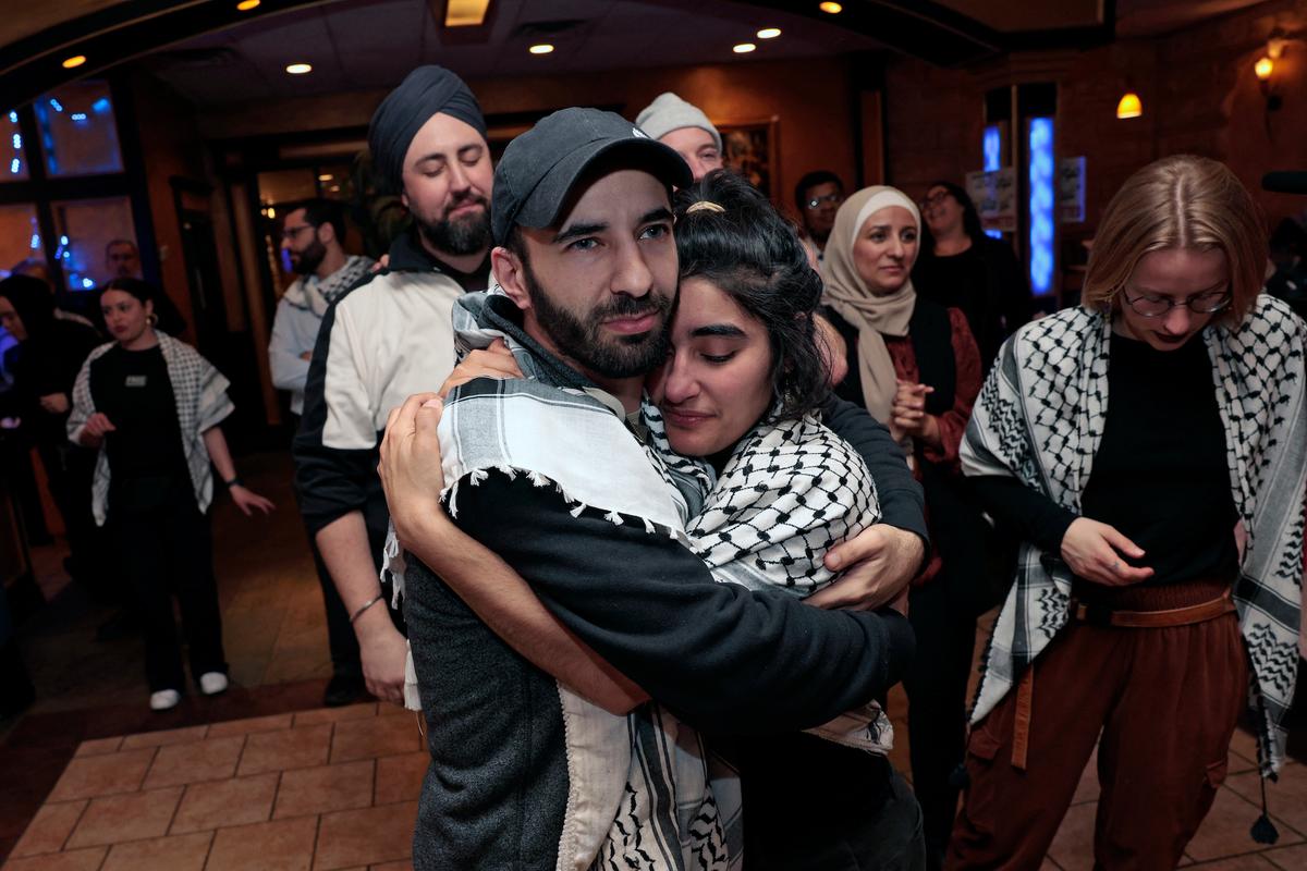People hug at the Listen to Michigan watch party during election night in Dearborn, Michigan, on Feb. 27, 2024. (Jeff Kowalsky/AFP)