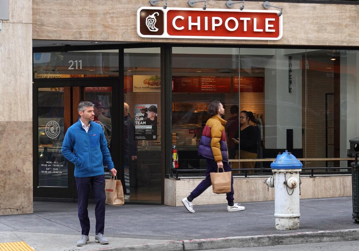 Pedestrians walk by a Chipotle restaurant in San Francisco on April 26, 2022. (Justin Sullivan/Getty Images)