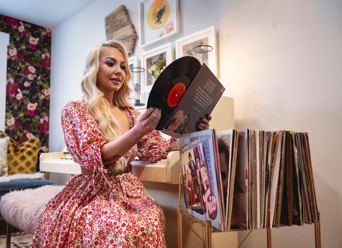 RaeLynn peruses her favorite records. This part of her house is where she goes to make music. (Adhiraj Chakrabarti for American Essence)