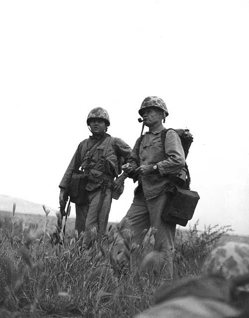 Lewis Burwell "Chesty" Puller (R) surveys the terrain during the Korean War. He was known for his characteristic pipe. (Public Domain)