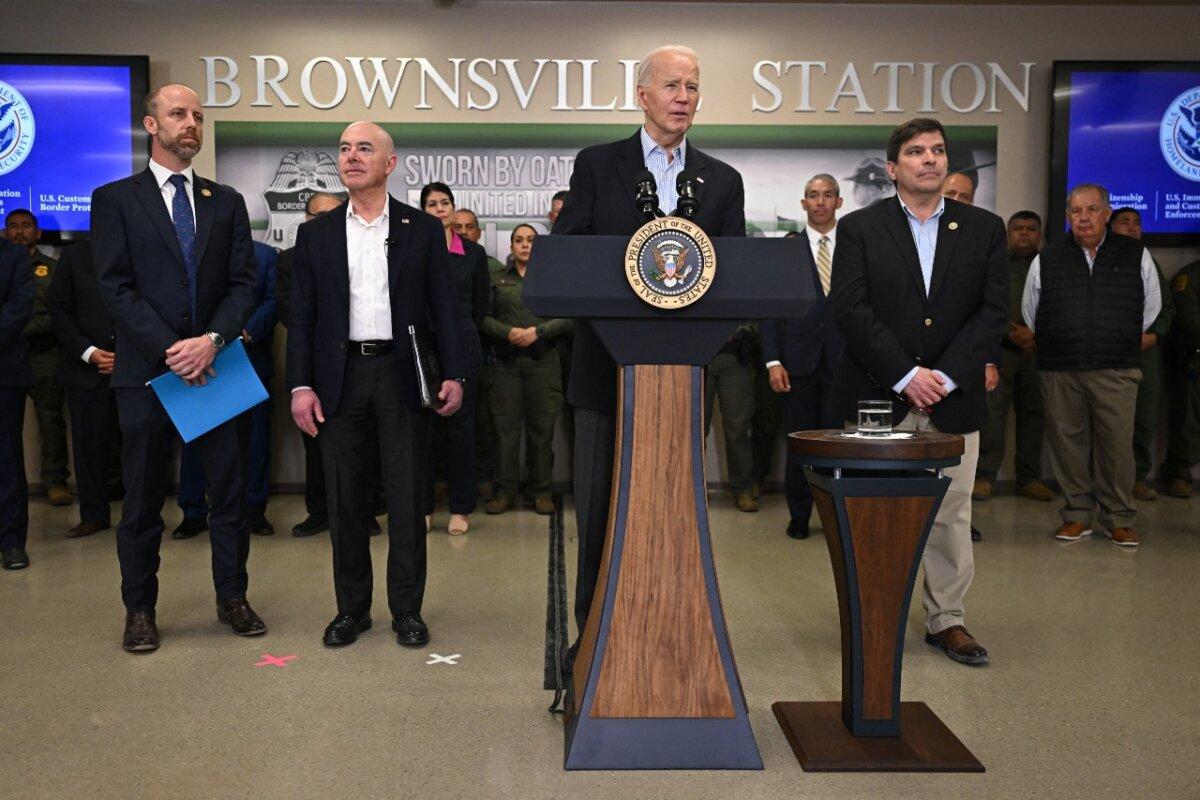 President Joe Biden (C), flanked by Brownsville Mayor John Cowen (L), Homeland Security Secretary Alejandro Mayorkas (2nd L), and Rep. Vicente Gonzalez (D-Texas), speaks about immigration at the Brownsville Station during a visit to the U.S.–Mexico border in Brownsville, Texas, on Feb. 29, 2024. (Jim Watson/AFP via Getty Images)