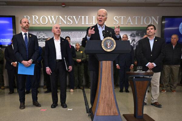 U.S. President Joe Biden (C) flanked by Brownsville, Texas, Mayor John Cowen (L), Homeland Security Secretary Alejandro Mayorkas (2nd L) and Rep. Vicente Gonzalez (D-Texas), speaks about immigration at the Brownsville Station during a visit to the U.S.–Mexico border in Brownsville, Texas, on Feb. 29, 2024. (Jim Watson/AFP via Getty Images)