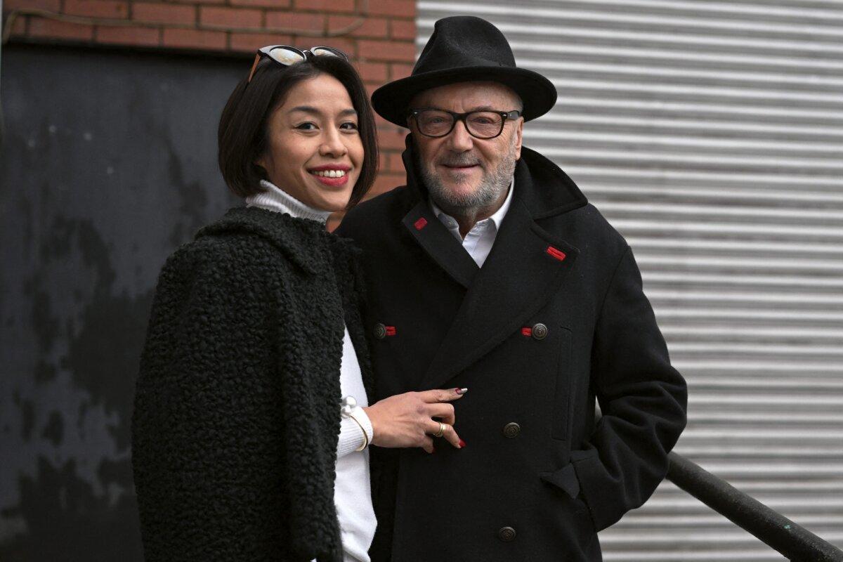 The new Workers Party member of Parliament for Rochdale, George Galloway, poses for a photograph with his wife Putri Gayatri Pertiwim outside his campaign headquarters in Rochdale, northern England on March 1, 2024. (Oli Scarff/AFP via Getty Images)