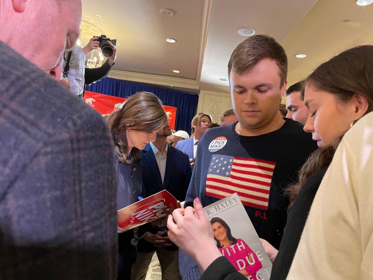 Parker Boggs (C), from James Madison University, waits to get Republican presidential candidate Nikki Haley's autograph at her campaign event in Washington on March 1, 2024. (Terri Wu/The Epoch Times)