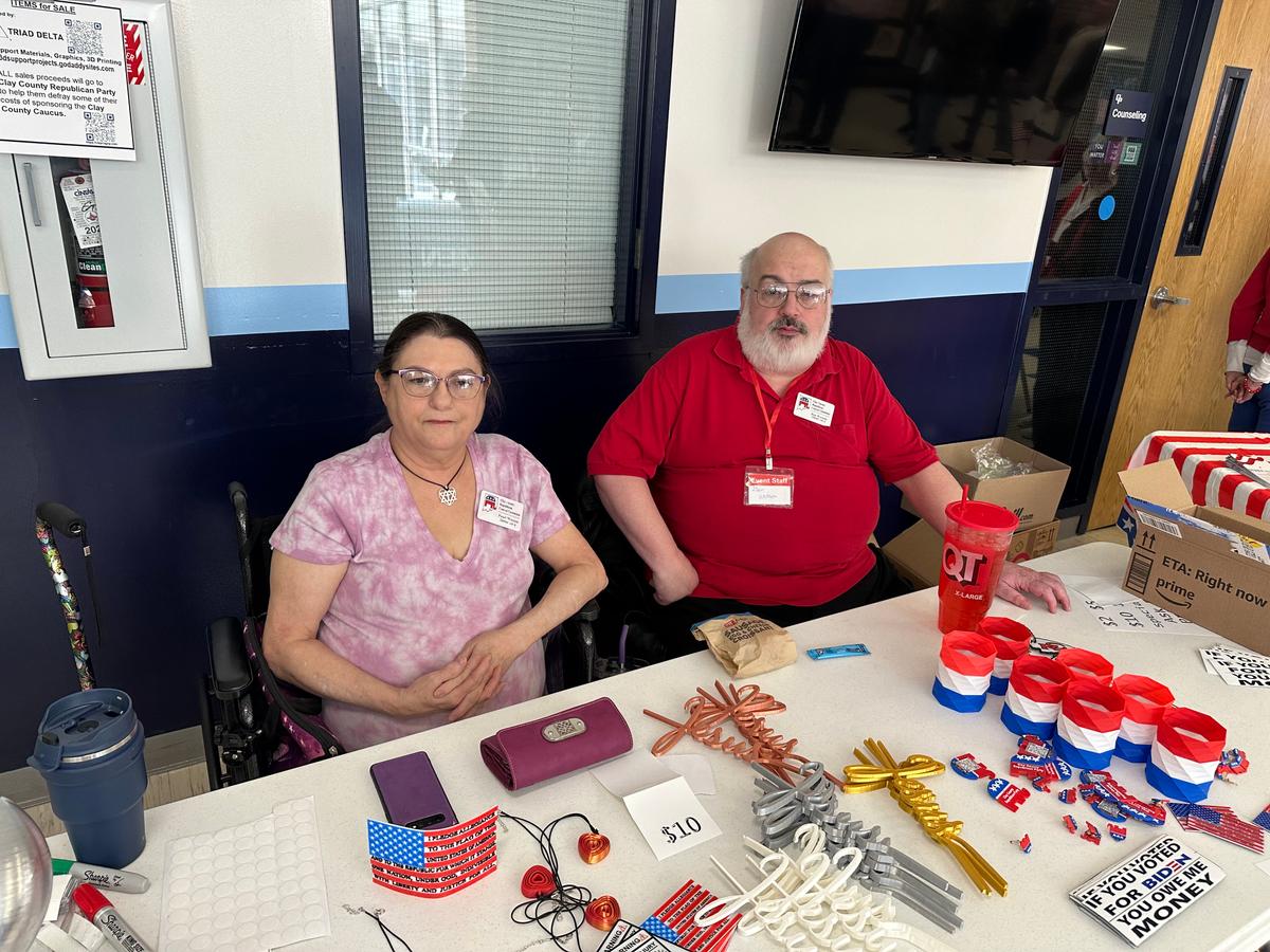 Ben Watson and Pearl Watson, of Gladstone, Missouri, sell memorabilia to support the Republican Party of Clay County ahead of the county's caucus on Saturday, March 2, 2024. (Austin Alonzo/The Epoch Times)