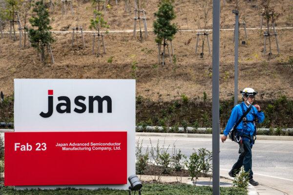 A worker walks outside the new semiconductor plant by Japan Advanced Semiconductor Manufacturing Company (JASM), a subsidiary of Taiwan's chip giant TSMC (Taiwan Semiconductor Manufacturing Company), in Kikuyo of the Kikuchi district, Kumamoto prefecture on Feb. 14, 2024. (Philip Fong/AFP via Getty Images)