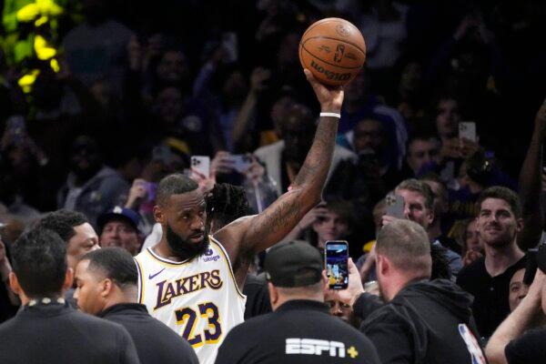 Los Angeles Lakers forward LeBron James acknowledges fans after scoring to become the first NBA player to reach 40,000 points in a career during the first half of an NBA basketball game in Los Angeles on March 2, 2024. (Mark J. Terrill/AP Photo)