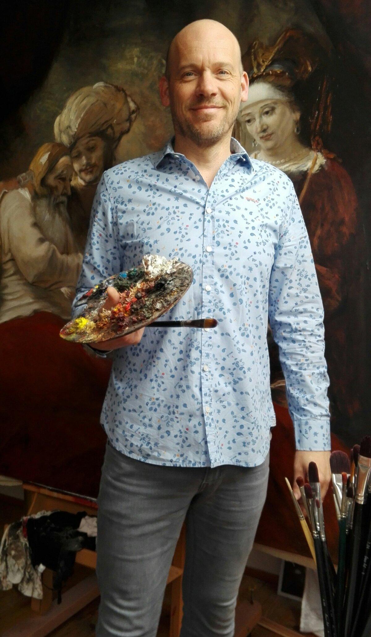 Artist Nard Kwast loves painting in the 17th-century style. He stands in front of a commissioned reproduction of Rembrandt's "Jacob Blessing the Sons of Joseph." (Courtesy of Nard Kwast)