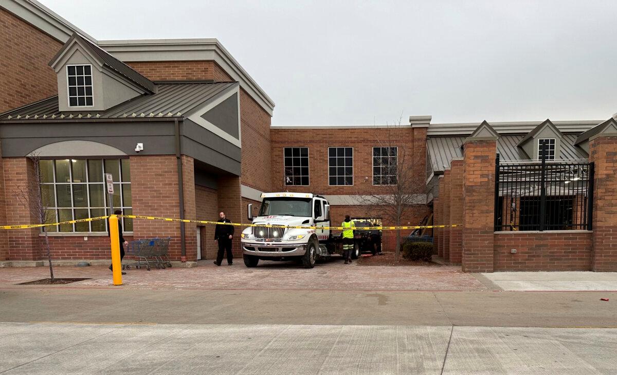 Crews work to remove a vehicle that had crashed into a Walmart store in Canton Township, Mich., on March 1, 2024. (Mike Householder/AP Photo)