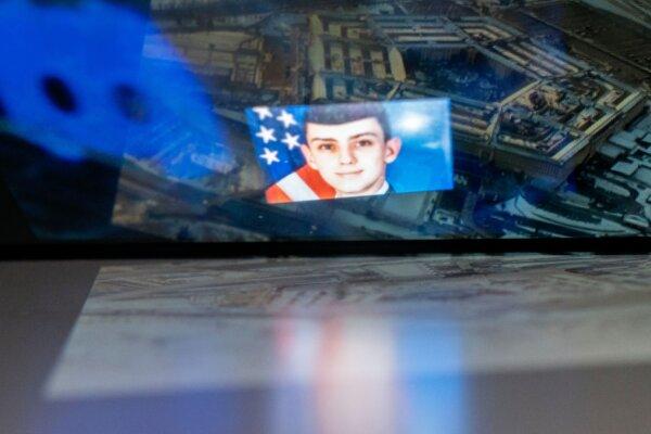 The Discord logo and the suspect, national guardsman Jack Teixeira, reflected in an image of the Pentagon in Washington on April 13, 2023. (Stefani Reynolds/AFP via Getty Images)