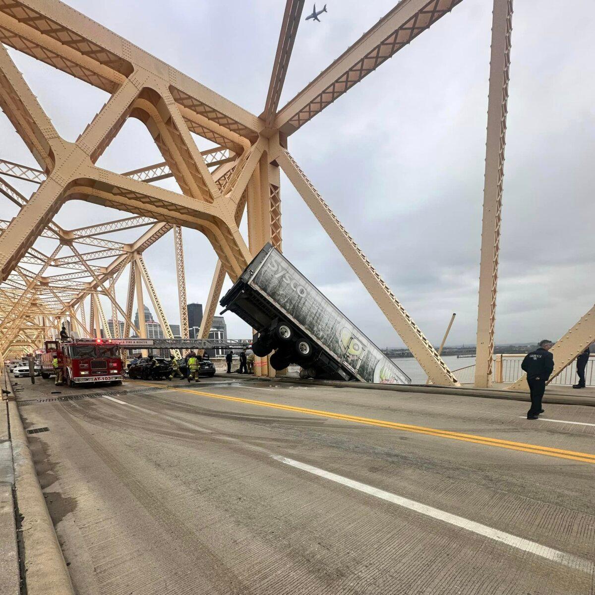 Louisville Fire Dept. rescue the driver of semitruck that is dangling off the Clark Memorial Bridge over the Ohio River in Louisville, Ky., on March 1, 2024. (Louisville Division of Fire via AP)