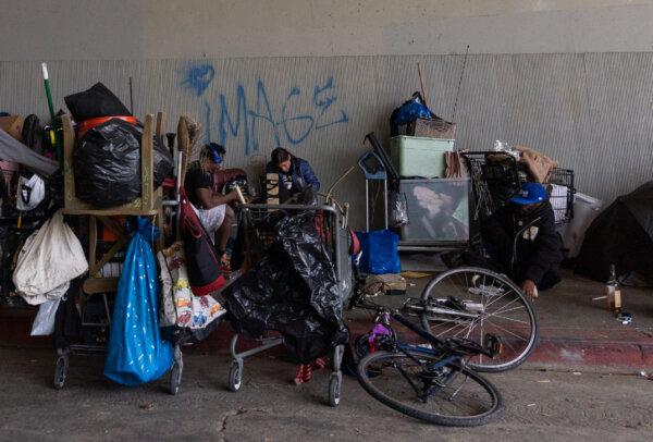 Men rest in a homeless encampment in Los Angeles on March 4, 2024. (John Fredricks/The Epoch Times)
