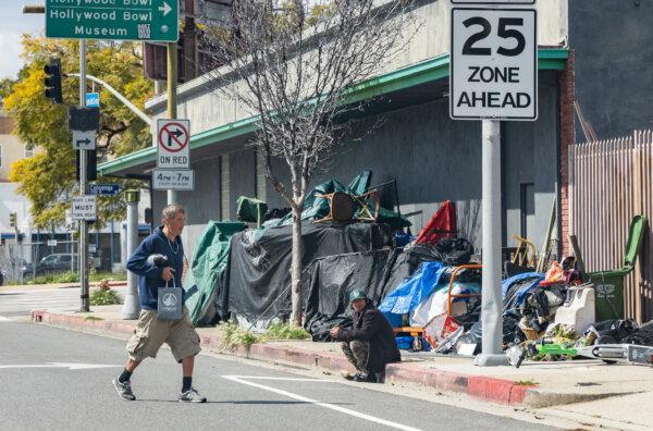 Men near a homeless encampment in Los Angeles on March 4, 2024. (John Fredricks/The Epoch Times)