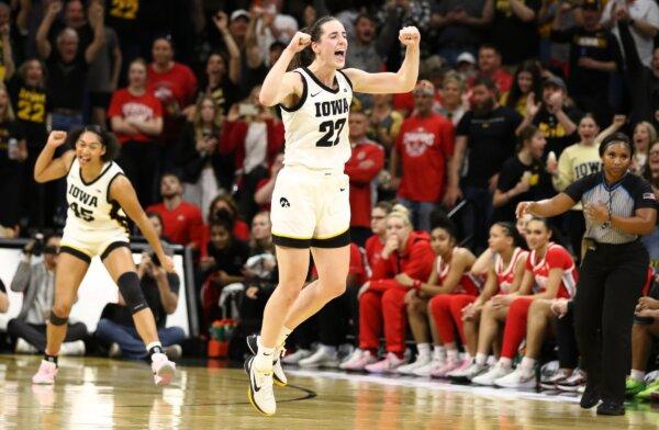 Guard Caitlin Clark (22) of the Iowa Hawkeyes celebrates after breaking Pete Maravich's all-time NCAA scoring record during the first half against the Ohio State Buckeyes in Iowa City, Iowa on March 3, 2024. (Matthew Holst/Getty Images)
