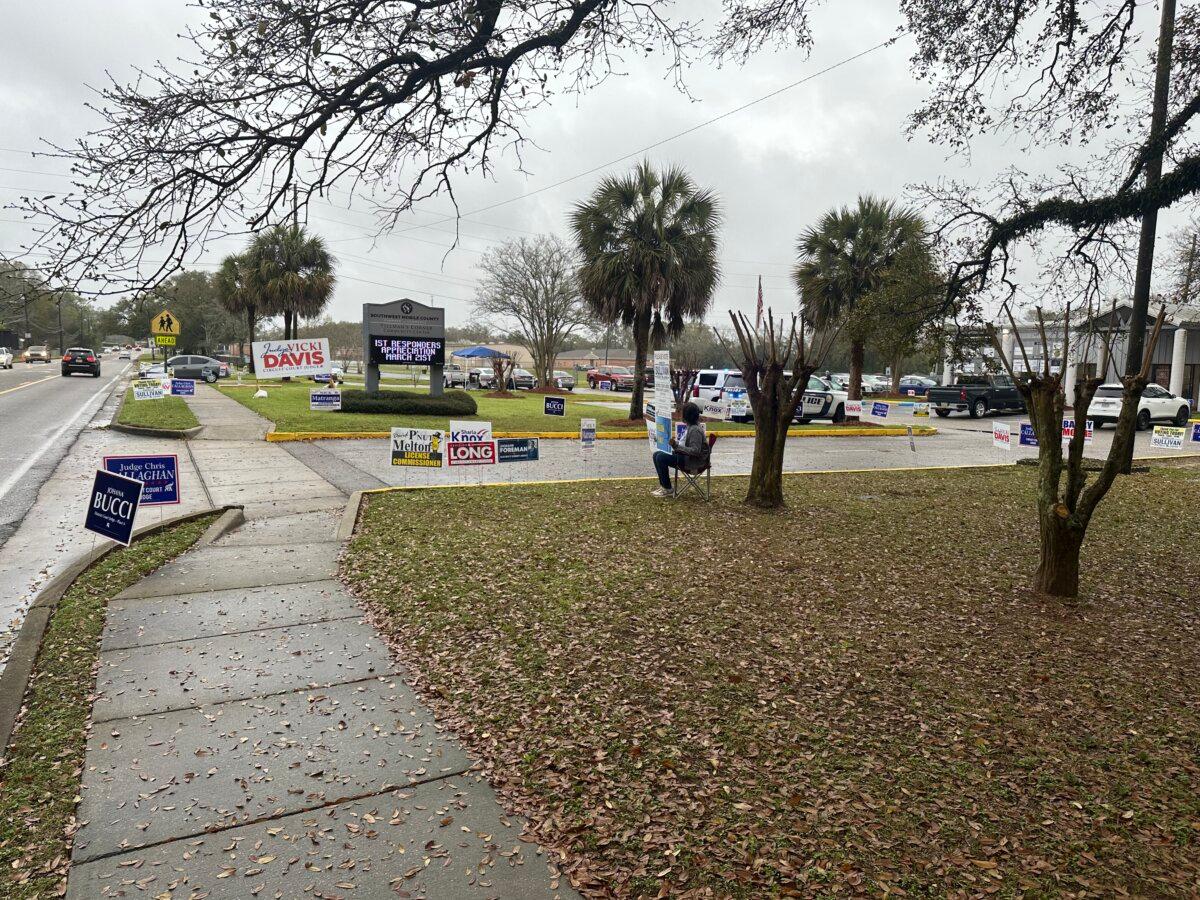 Signs and sign wavers greet voters at the Tillman's Corner Community Center in Tillman's Corner, Alabama, on Tuesday, March 5, 2024. (Austin Alonzo/The Epoch Times)