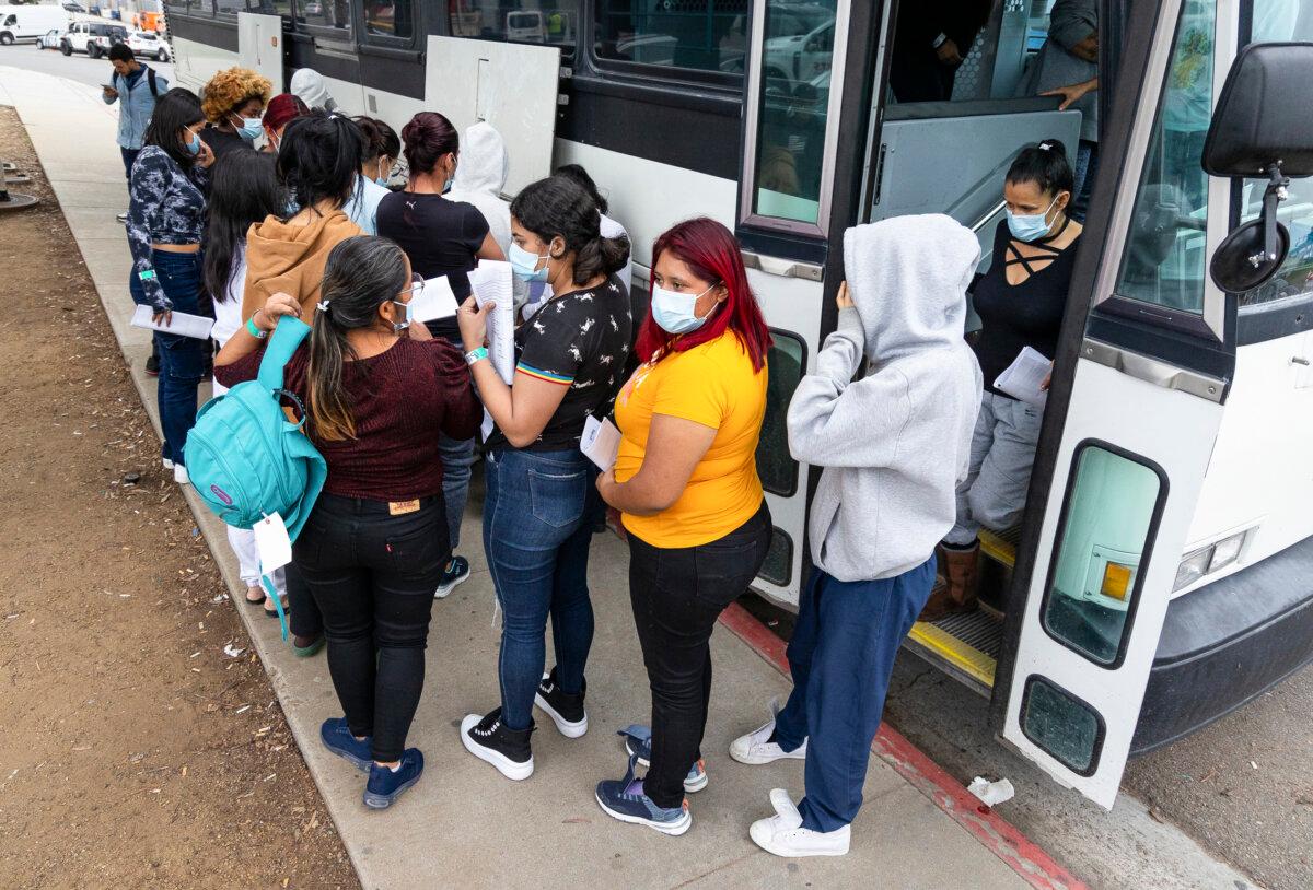 Buses drop off large groups of illegal immigrants in San Ysidro, Calif., on Feb. 29, 2024. (John Fredricks/The Epoch Times)