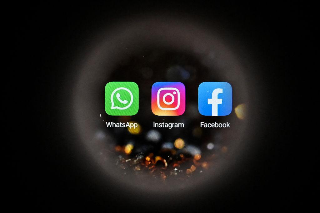 This picture taken in Moscow on October 5, 2021 shows the US online social media and social networking service Facebook's logo (R), the US instant messaging software Whatsapp's logo (L) and the US social network Instagram's logo (C) on a smartphone screen. (Kirill Kudryavtsev/AFP via Getty Images)