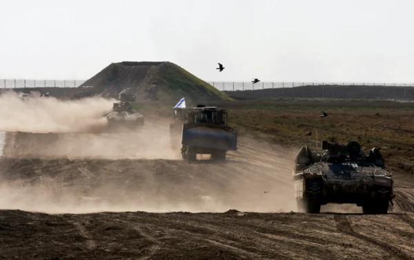 Military vehicles maneuvre near the Israel-Gaza border fence, amid the ongoing war between Israel and Hamas, in Israel, on March 4, 2024. (Ammar Awad/Reuters)