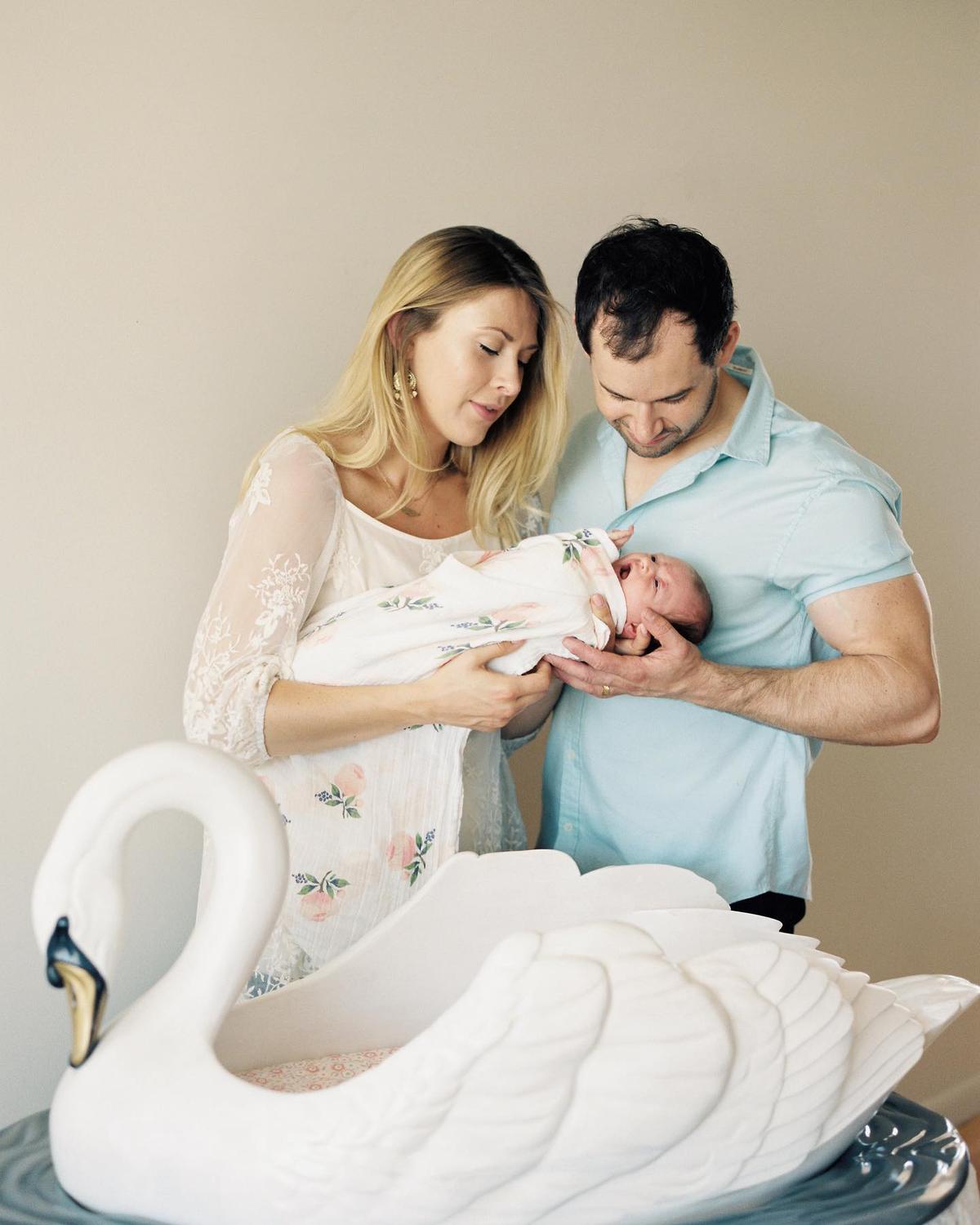 Hannah and Jake holding their first baby, Emma. (Courtesy of Hannah Weidmann)