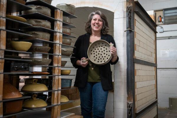 Morgan Baum, owner and CEO of Clay Coyote, poses in the kiln room with one of her flameware pottery grill baskets in Hutchinson, Minnesota, Friday, Jan. 26, 2024. (Leila Navidi/Minneapolis Star Tribune/TNS)