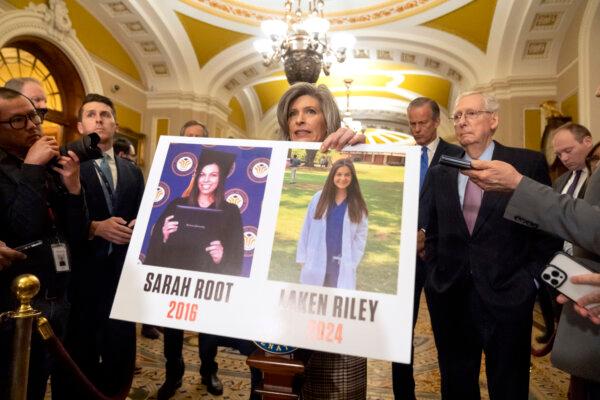 Sen. Joni Ernst (R-Iowa) holds a poster with photos of murder victims Sarah Root and Laken Riley as she speaks on Capitol Hill in Washington on Feb. 27, 2024. (Mark Schiefelbein/AP Photo)