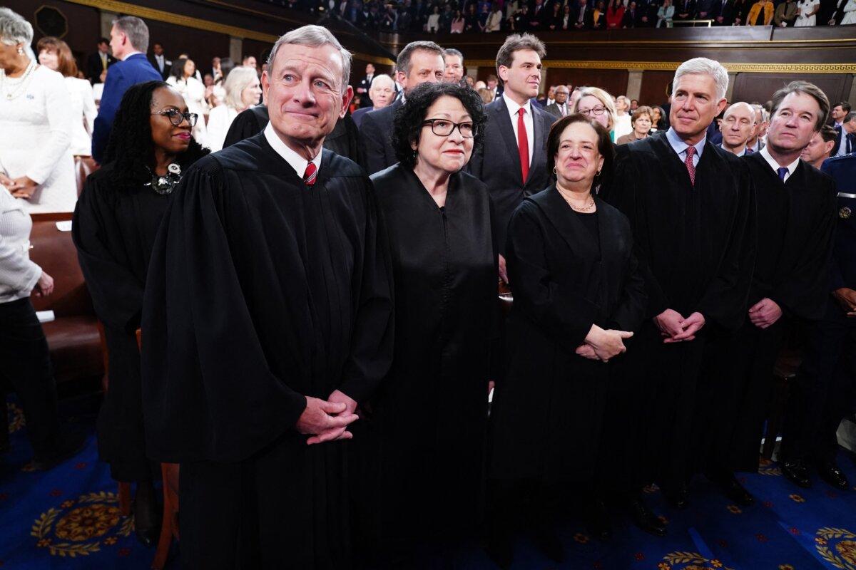Chief Justice of the Supreme Court John Roberts (L), along with Associate Justices (L-R) Sonia Sotomayor, Elena Kagan, Neil Gorsuch, Brett Kavanaugh and Ketanji Brown Jackson (back) stand in the House of Representatives ahead of US President Joe Biden's third State of the Union address to a joint session of Congress in the House Chamber of the US Capitol on March 7, 2024. (Shawn Thew/Pool/AFP via Getty Images)