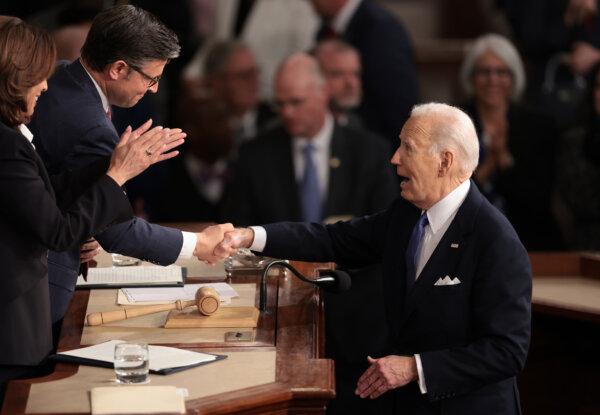 President Joe Biden shakes hands with Speaker of the House Mike Johnson (R-LA) as Vice President Kamala Harris applauds after he delivered the State of the Union address during a joint meeting of Congress in the House chamber at the U.S. Capitol on March 07, 2024 in Washington, DC. (Win McNamee/Getty Images)