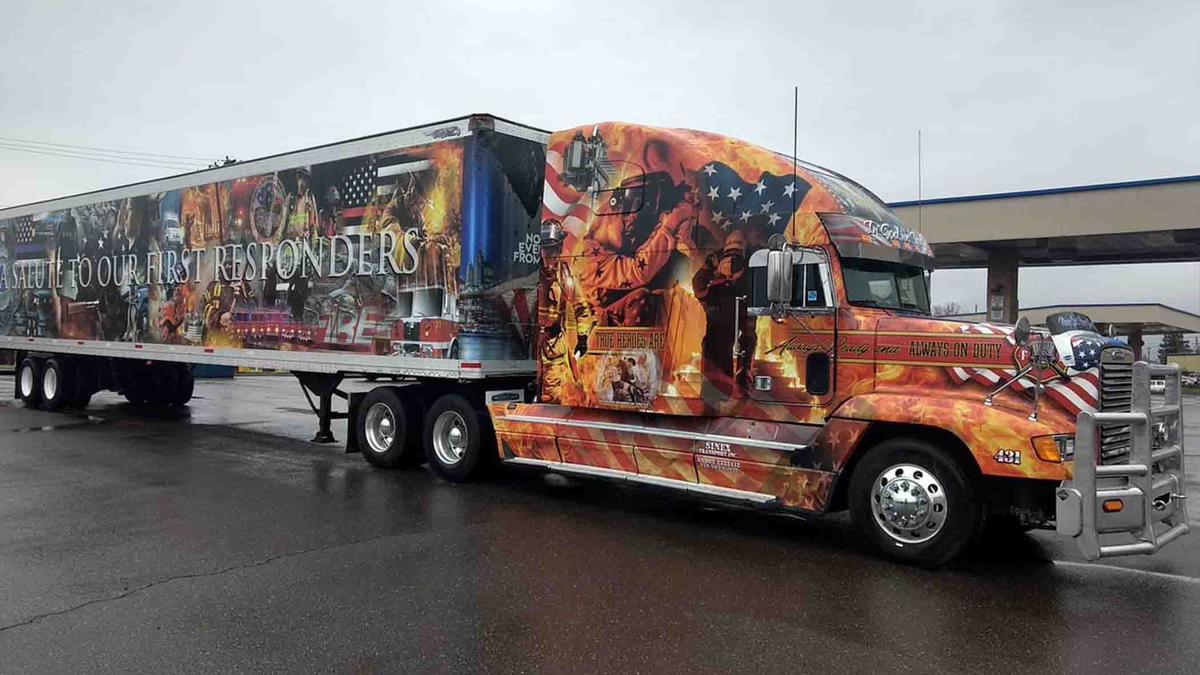 Flames engulf half of the semi-trailer truck devoted to honoring first responders. (Courtesy of <a href="https://www.facebook.com/FLD431">Forged By Fire</a>)