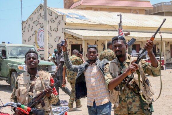 Sudanese army soldiers, loyal to army chief Abdel Fattah al-Burhan, pose for a picture at the Rapid Support Forces (RSF) base in the Red Sea city of Port Sudan on April 16, 2023 (Photo by -/AFP via Getty Images)