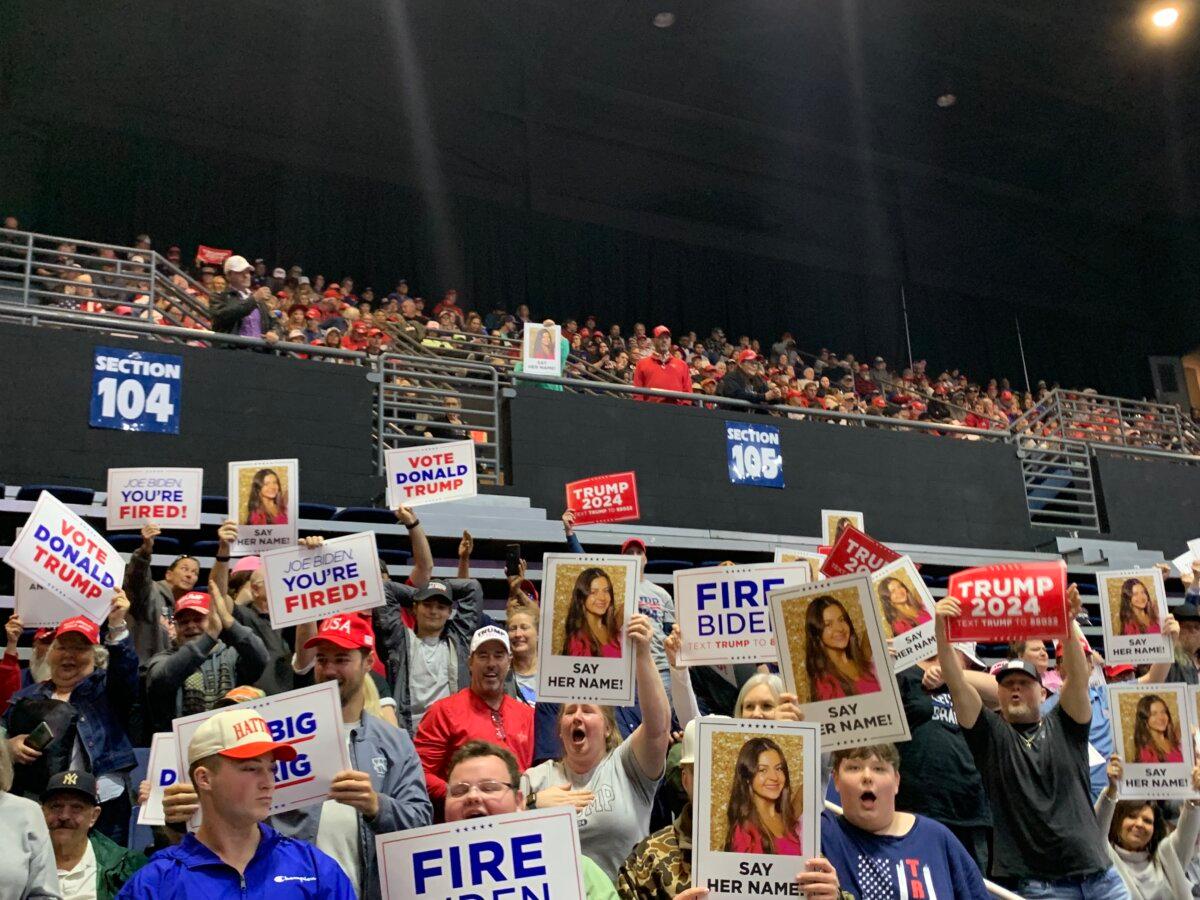 Trump supporters hold up signs featuring Laken Riley at a rally in Rome, Ga. on March 9, 2024 (T.J. Muscaro/The Epoch Times)