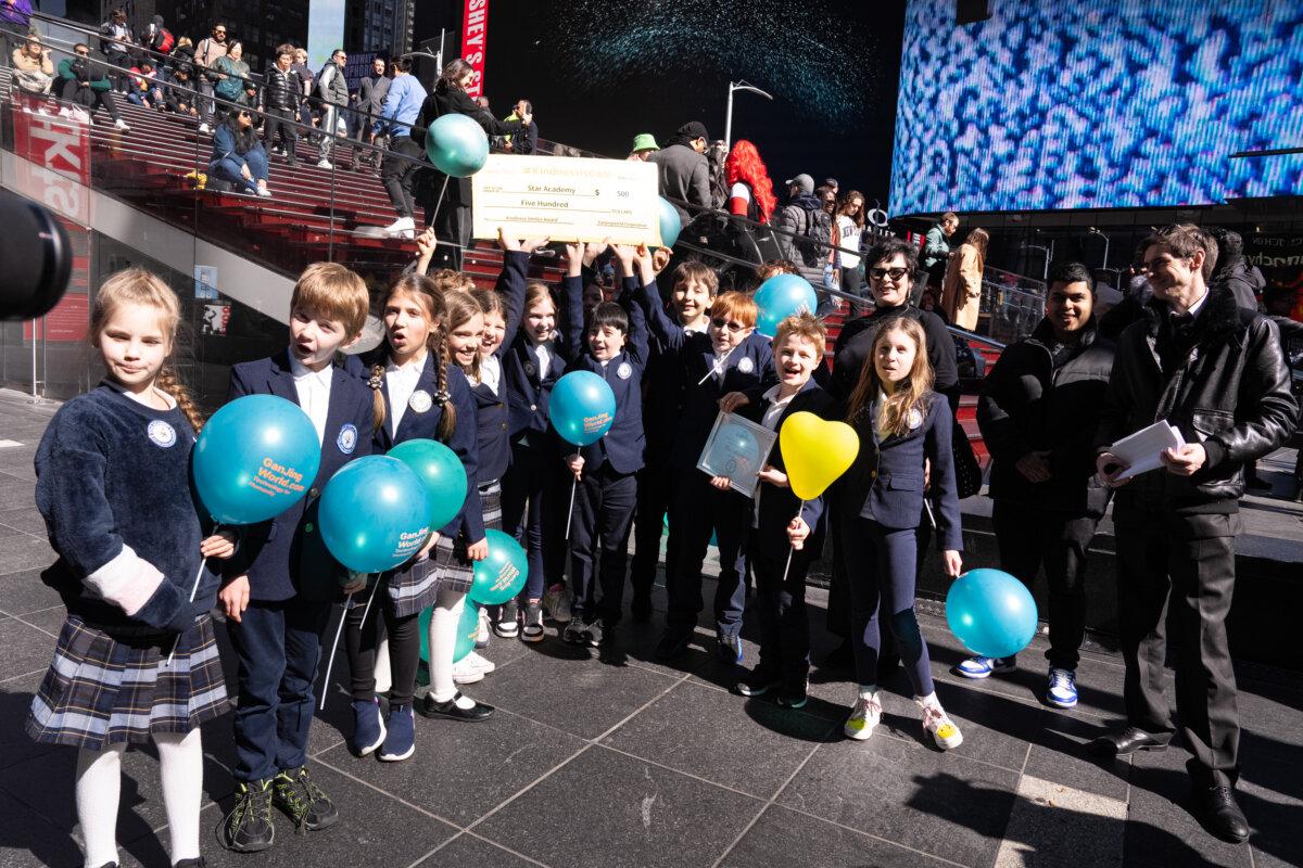 Group of students of Star Academy for the Gifted and Talented, winner of the "Kindness Smiles Award," at Gan Jing World's "Kindness Is Cool Video Awards" ceremony at Times Square, New York, on March 8, 2024. (Larry Dye/The Epoch Times)