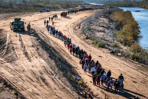 Republican Warns Biden Order Allowing Illegal Immigrants and Felons to Vote 2 in this aerial view, A group of more than 1,000 illegal aliens walk towards a U.S. Border Patrol field processing center after they crossed the Rio Grande from Mexico in Eagle Pass, Texas, on Dec. 18, 2023. (John Moore/Getty Images)