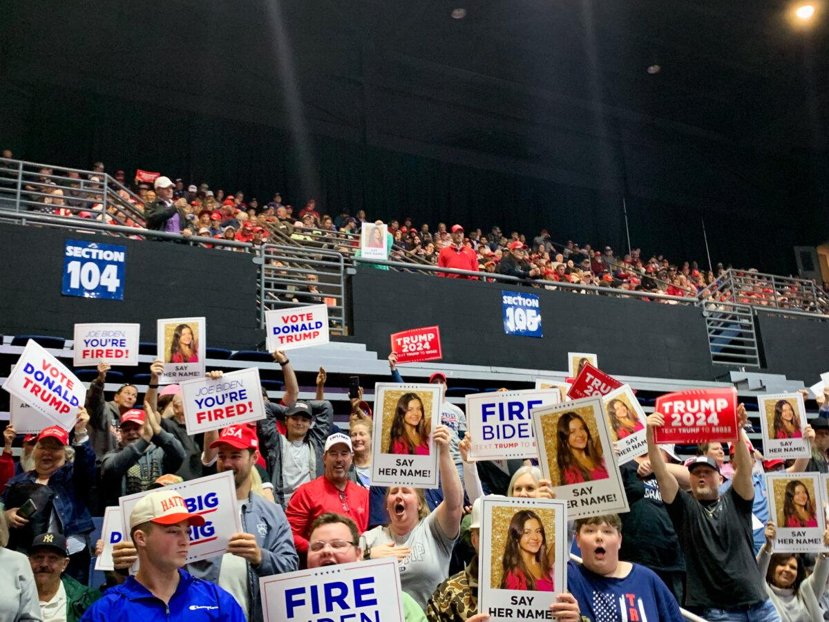 Trump supporters hold up signs featuring Laken Riley at a rally in Rome, Ga., on March 9, 2024 (T.J. Muscaro/The Epoch Times).