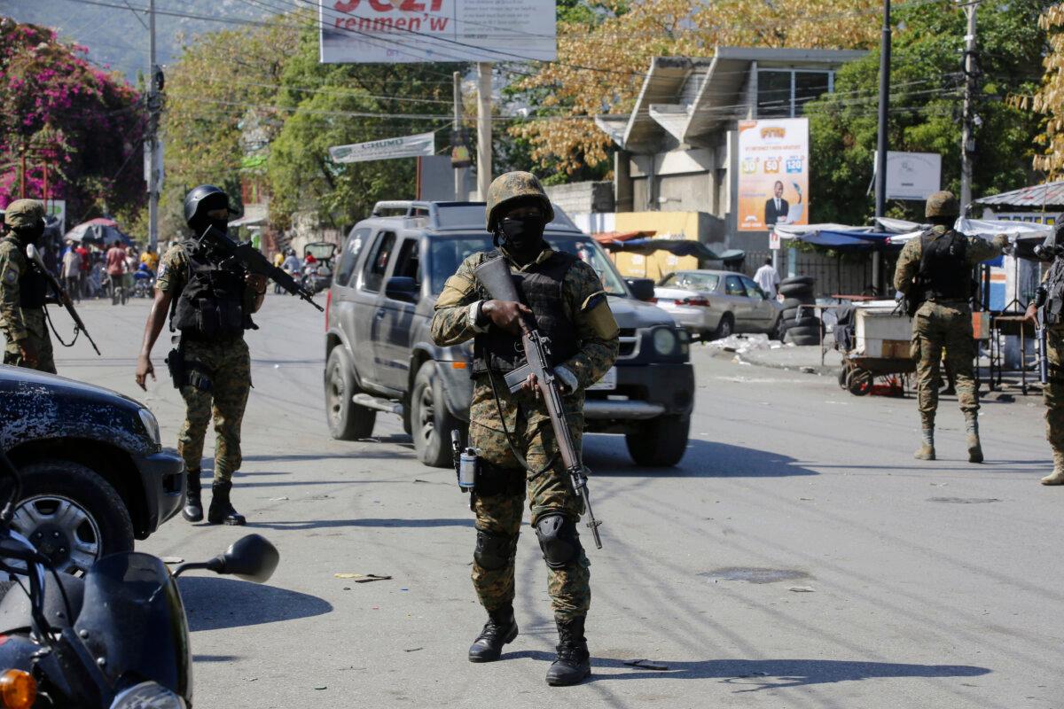 Members of the General Security Unit of the National Palace, USGPN, set up a security perimeter around one of the three downtown stations after police fought off an attack by gangs the day before, in Port-au-Prince, Haiti, on March 9, 2024. (Odelyn Joseph/AP Photo)