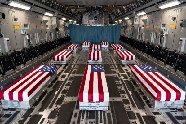 Flag-draped transfer cases line the inside of a C-17 Globemaster II on Aug. 29, 2021, prior to a dignified transfer at Dover Air Force Base, Del. The fallen service members died while supporting non-combat operations in Kabul. (U.S. Air Force photo by Jason Minto)